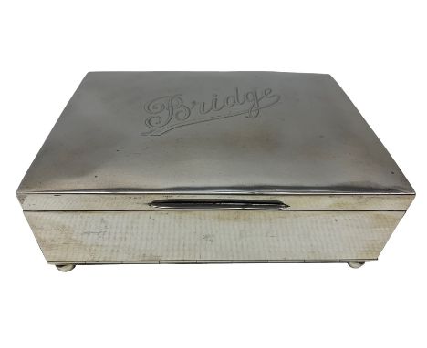 Edwardian silver rectangular playing card box, the hinged lid engraved 'Bridge' with divided interior and on ball feet 15cm x