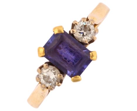 A modern 18ct gold three stone iolite and diamond ring, maker AJW, London 2002, prong set with rectangular step-cut iolite an