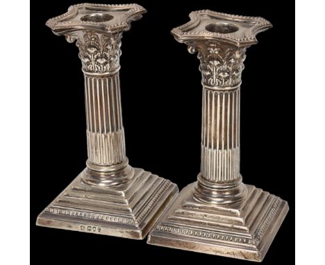 A pair of Victorian silver Corinthian column squat table candlesticks, William Hutton & Sons Ltd, London 1894, with removeabl