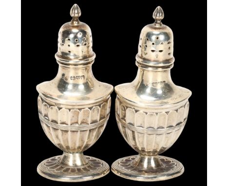 A pair of George V silver Adams style urn pepperettes, indistinct maker, Chester 1920, 10cm, 2.3ozBoth are quite worn, 1 is s