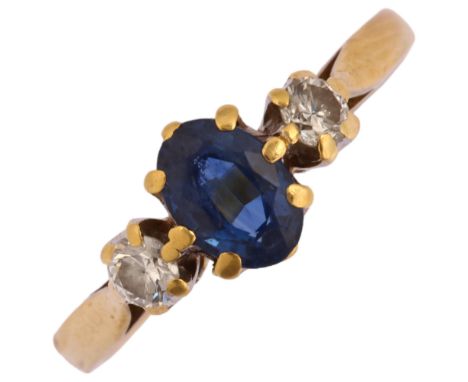 A late 20th century 18ct gold three stone sapphire and diamond ring, maker HOW, London 1994, prong set with oval mixed-cut sa