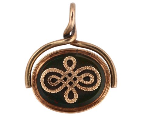 An early 20th century bloodstone and carnelian swivel spinner fob, unmarked yellow metal frame with applied gold decoration, 