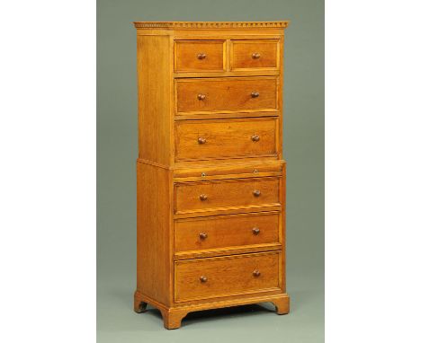 An oak tallboy, in two sections, with dentil cornice above two short and two long drawers, the base fitted with a slide with 