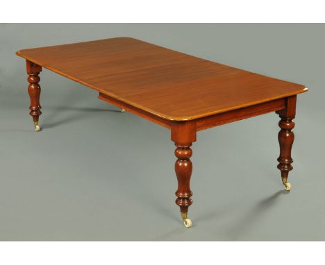 A Victorian mahogany extending dining table, with two leaves, with moulded edge and rounded corners and raised on turned legs