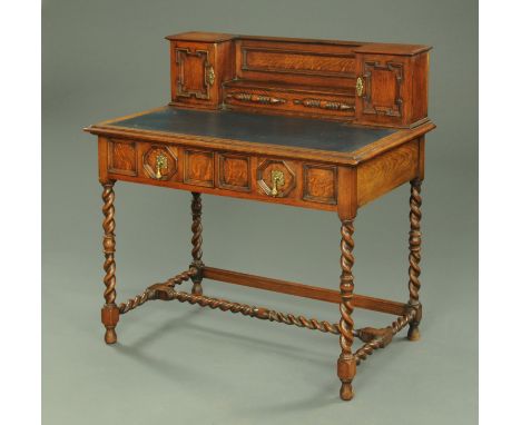 A Shapland & Petter oak desk, with rear upstand and leatherette writing surface, with two frieze drawers and barley sugar twi
