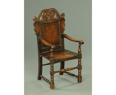 Charles II style child's chair, late 19th century, with a scrolling pediment of the inset panel back with solid seat and wavy