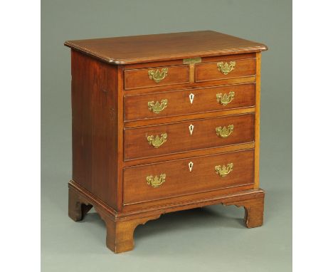 A George III style chest of drawers, small proportions, with rectangular top with moulded edge and rounded corners above two 
