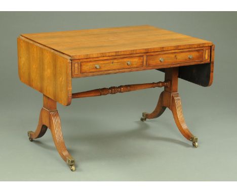 A Regency rosewood sofa table, fitted with two drawers to either side and raised on silhouette supports with downswept legs t