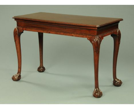 A Georgian mahogany console table, the rectangular top with moulded edge and re-entrant corners supported by a recessed friez