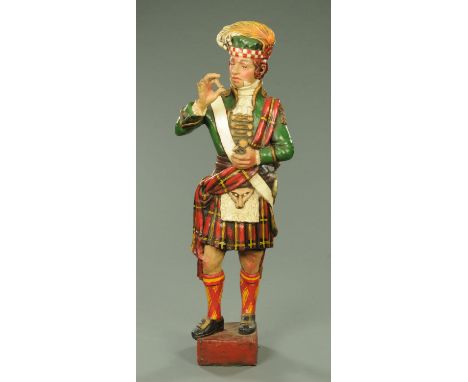 A composition figure of a Scotsman in Highland dress taking snuff, probably a tobacconists advert.  Height 138 cm (see illust