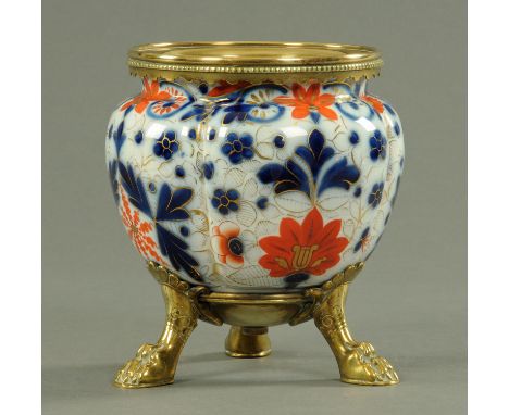 A Pirkenhammer melon shaped oil lamp base, cica 1887-1890, decorated in the Imari palette on a melon shaped body supported up