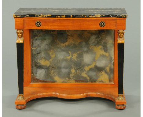 An Empire style satinwood console table, with variegated marble top, raised on tapering pilasters with low shelf and with mir