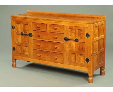 A Robert Mouseman Thompson of Kilburn sideboard, 1950's, with rear upstand, adzed top, fitted with a series of drawers and cu