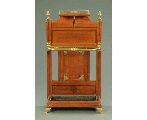 A mid Victorian mahogany and brass mounted stick stand, with three quarter galleried top, flanked by turned finials above a p