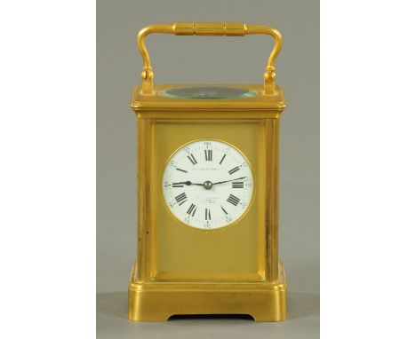 A Goldsmiths Co. French brass carriage clock, two-train striking on a gong, with circular dial with Roman numerals.  Height e