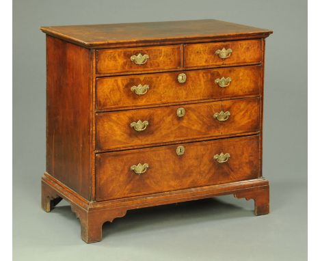 An 18th century walnut chest of drawers, with crossbanded moulded edge above two short and three long graduated drawers with 