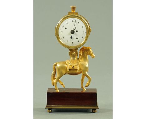 An early 19th century mantle clock, with three winding apertures to the enamelled dial, probably with alarm, advance and reta