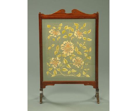 A needlework fire screen, early 20th century, floral decorated panel, width 53 cm, height 98.5 cm.