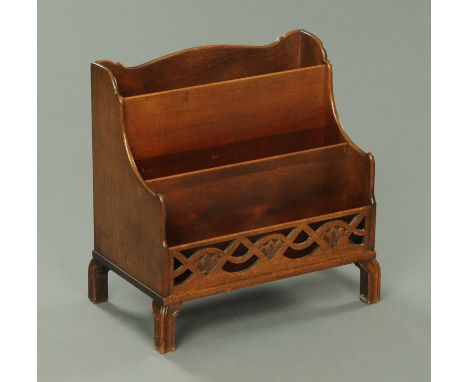 A mahogany waterfall Canterbury, with fretwork front panel and raised on short moulded legs.  Width 43 cm. 