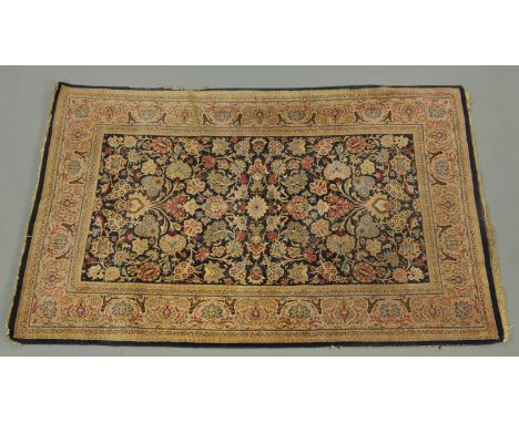 An antique Persian design rug, with centre rectangular panel and multiple line border, with dark blue ground.  218 cm x 137 c