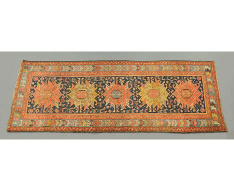 An Eastern runner, with five geometric designs to the centre panel and multiple line border.  284 cm x 108 cm (see illustrati