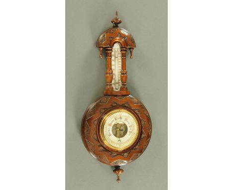 Late Victorian carved and stained beech barometer, the dial beneath a thermometer with milch glass gauge, struck numbers to t