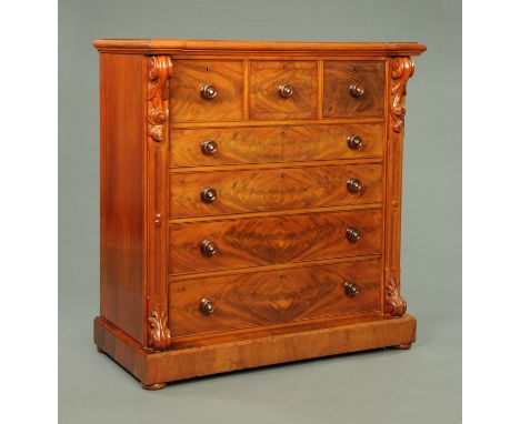 A Victorian mahogany scotch chest of drawers, with three deep over four long graduated drawers with wooden knob handles, flan