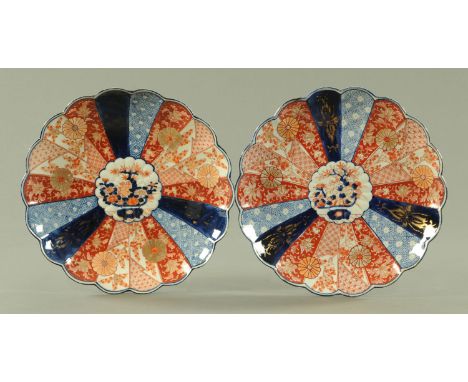 A pair of Japanese Imari chargers, circa 1890/1900, each centred with a jardiniere of flowers and framed by panels of diaper,