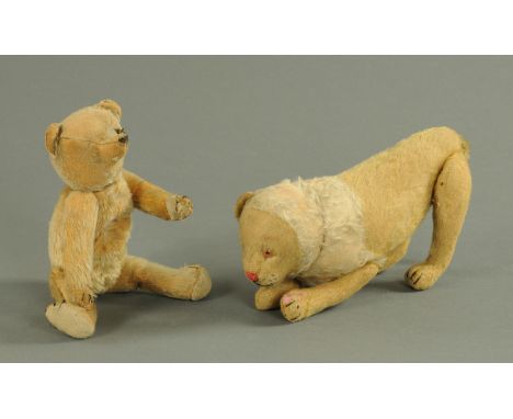 A vintage teddy bear, early 20th century, having a well worn plush body with one remaining button eye, 28 cm long and a simil