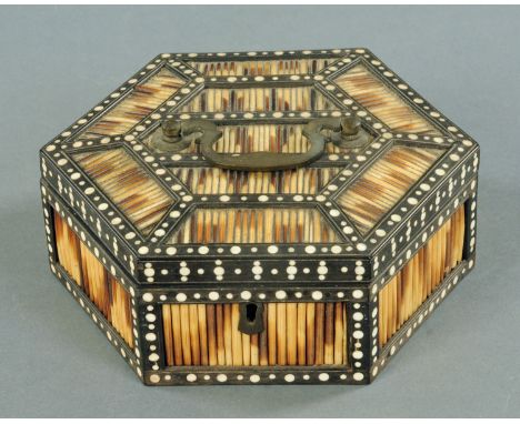 A 19th century Celanese quill work box from Matara, hexagonal, with inlaid large and small roundels on an ebony body, the int