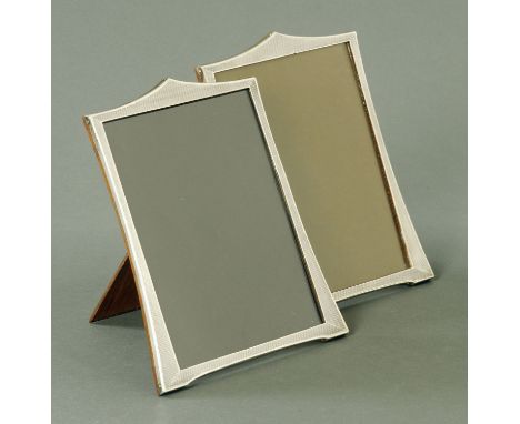 A pair of silver photograph frames, Samuel M Levi, Birmingham 1928, with engine turned decoration and upon an oak frame with 