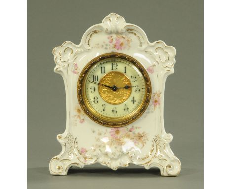 A Continental porcelain mantle clock, circa 1900, with an embossed gilt centre depicting a muse playing a lyre looking over a
