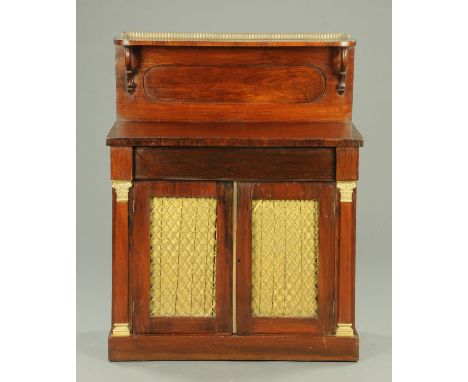 A Regency mahogany chiffonier, with brass gallery, shelf and pair of panelled doors with brass grilles and raised on a plinth