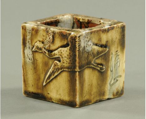 A Japanese Shigaraki type square vase, late 17th/early 18th century, of slab construction with two applied cranes in relief, 