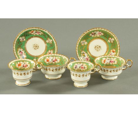A pair of Minton porcelain trios, mid 19th century, each interior with hand painted floral vignettes and framed by gilt scrol