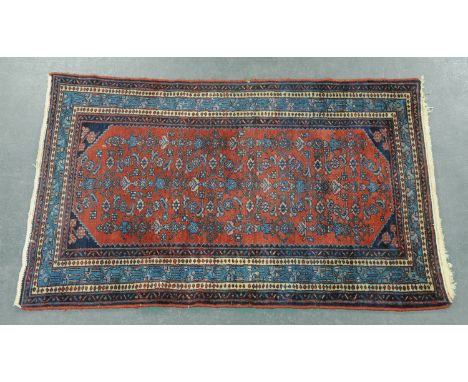 A Turkoman rug, last quarter 20th century, with centre rectangular panel with repeating decoration and multiple line border. 
