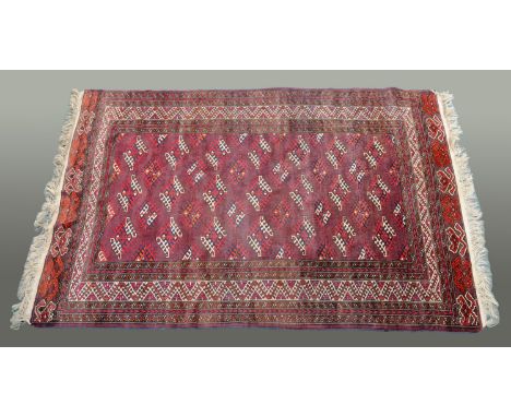 A Khiva fringed rug, last quarter 20th century, the centre rectangular panel with repeating diamond shaped decoration to a pu