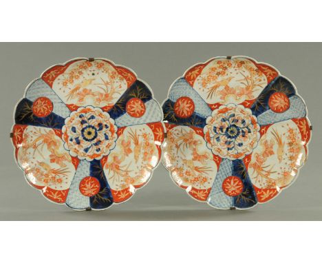 A pair of Japanese Imari scalloped shaped chargers, circa 1890/1900, decorated with fan shaped panels of birds amongst blosso