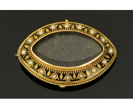 A Victorian gold metal and black enamel mourning brooch, set with seed pearls, the centre with plaited hair, the reverse also