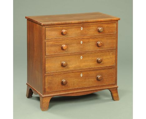 A Regency mahogany chest of drawers, with crossbanded moulded edge above four long graduated drawers with wooden knob handles