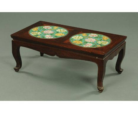 A Chinese hardwood coffee table, inset with chrysanthemums cloisonne plaques against a turquoise ground.  83 cm x 46 cm x 32 