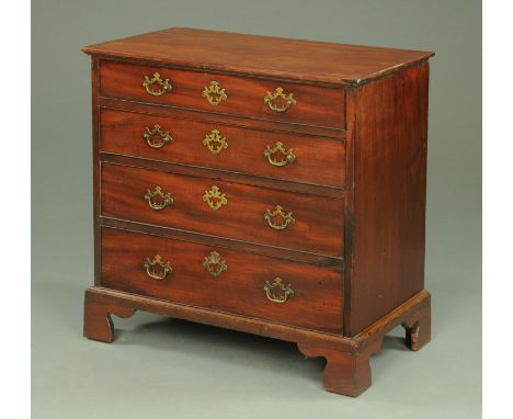 A George III mahogany chest of drawers, with crossbanded top above four graduated oak lined drawers each with brass drop hand