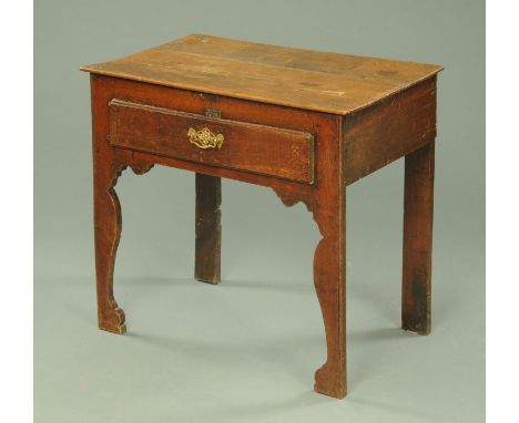 A Georgian oak lowboy, with single drawer and later brass drop handle and with silhouette supports.  Width 75 cm.  CONDITION 