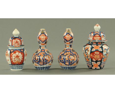 A pair of Japanese Imari double gourd shaped vases, circa 1880, in typical Imari colours but with turquoise accents, heighten