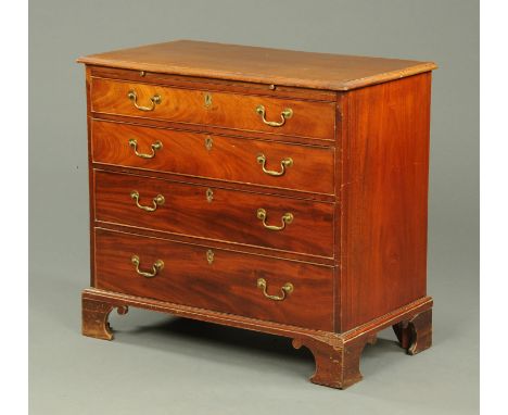 A George III mahogany chest of drawers, with moulded edge above a brushing slide and four long graduated drawers with brass d