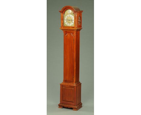 A walnut cased grandmother clock, with three-train spring driven movement, with long trunk door and all raised on bracket fee