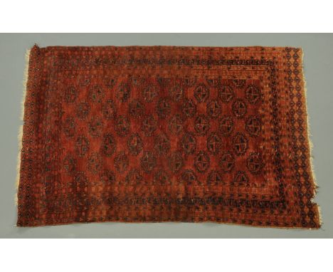 An Eastern rug, with centre rectangular panel with repeating geometric design and multiple line border, with fringed ends, pr