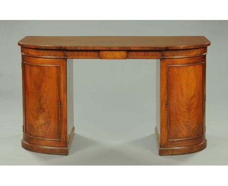 A Regency mahogany cross banded sideboard in the manner of Gillows of Lancaster, with breakfront and rounded corners, single 