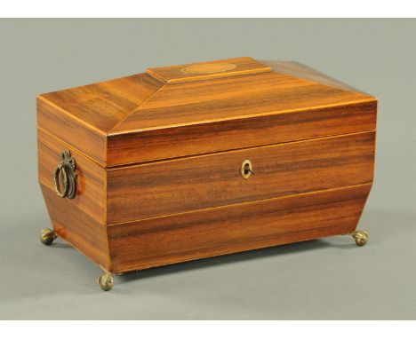 A Regency rosewood sarcophagus shaped tea caddy, shell inlaid and with two lidded compartments and glass bowl to the interior