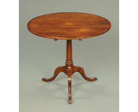 A George III oak and mahogany crossbanded tripod table, with snap action to turned column, the three downswept legs terminati